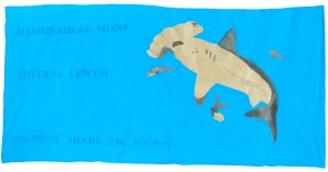 Scalloped Hammerhead Shark by John D, Bharath J, Jason L, and Diego R. Ms Harad's 6th grade class, Thomas Starr King Middle School, 2014. Painted and embroidered fabric appliqué with rubber stamps.