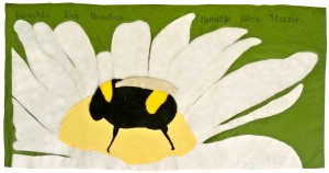 Bumble Bee by Arabella H, Nicole, Matea, and Chela, Ms Rabina's 6th grade class 2014, Thomas Starr King Middle School. Felt, faux fur, and fabric appliqué, with rubber stamps.